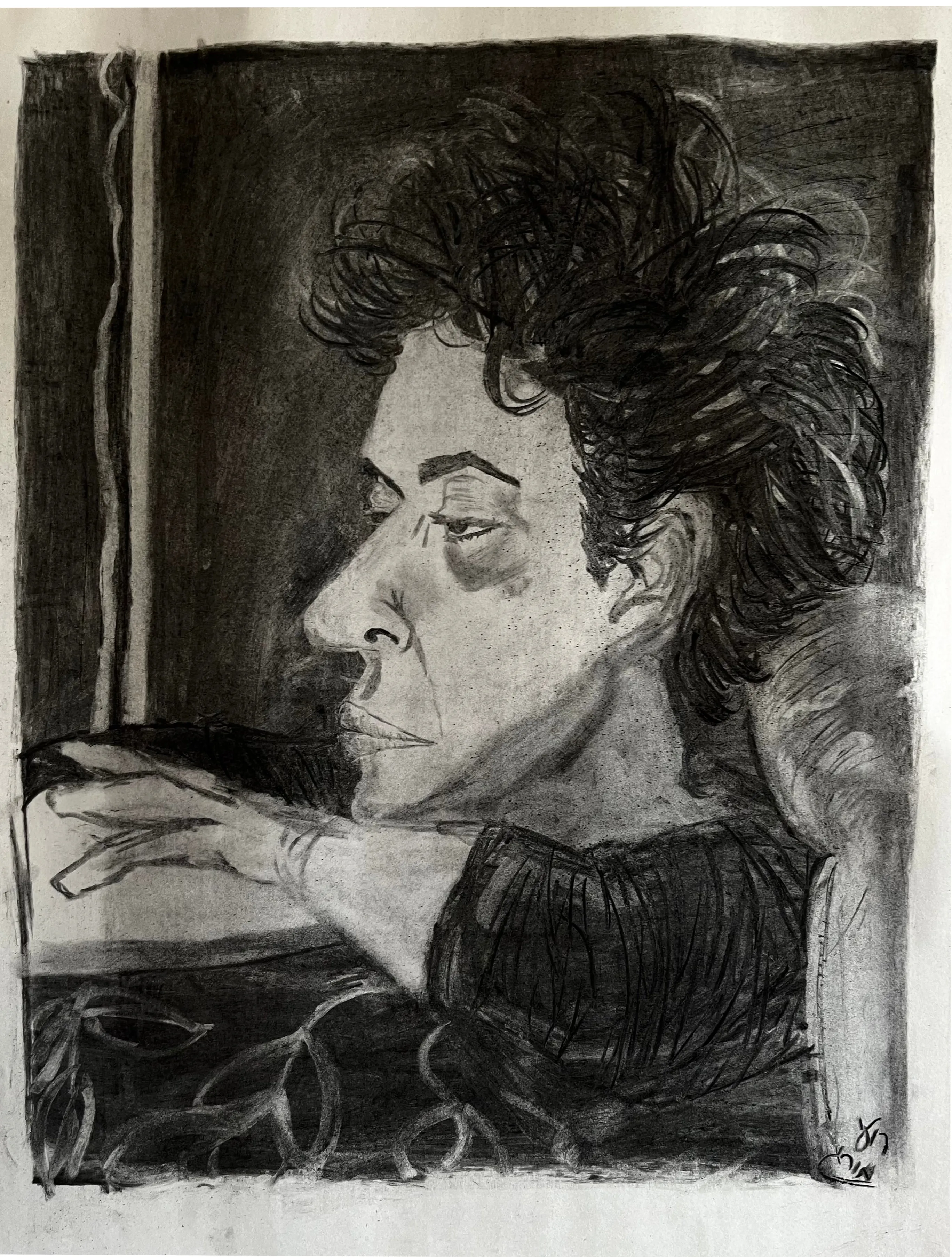 A charcoal portrait of a man in profile with dark curly hair, leaning on his forearm.