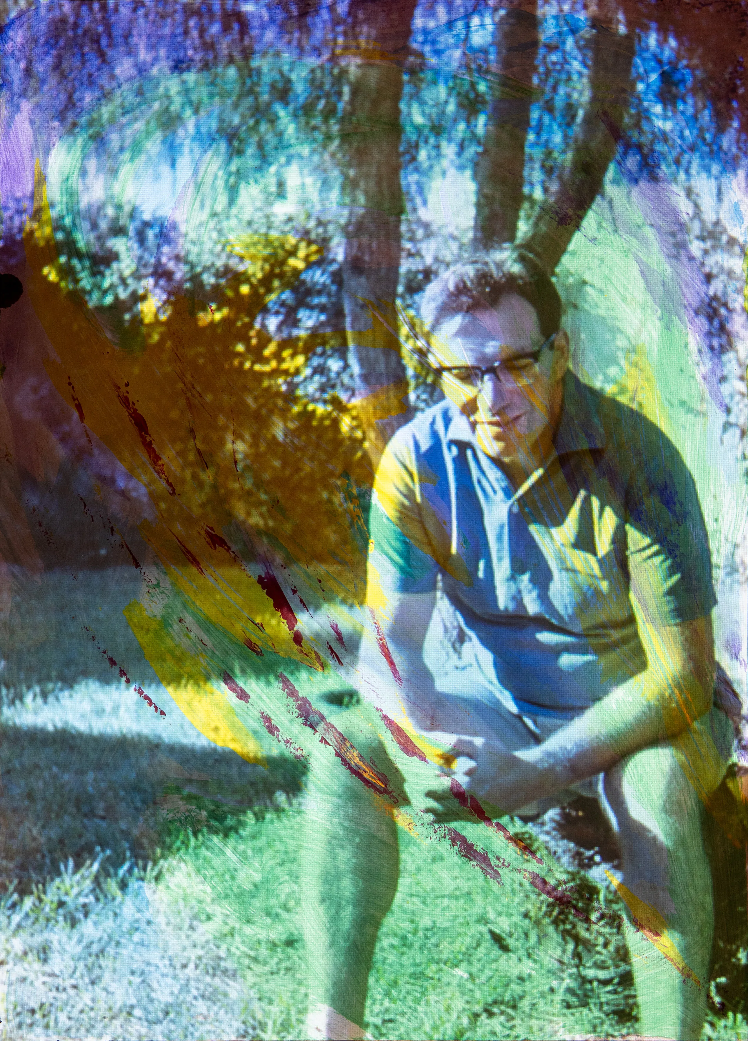 A man with glasses sits outdoors among trees, tinted blue, yellow and purple.