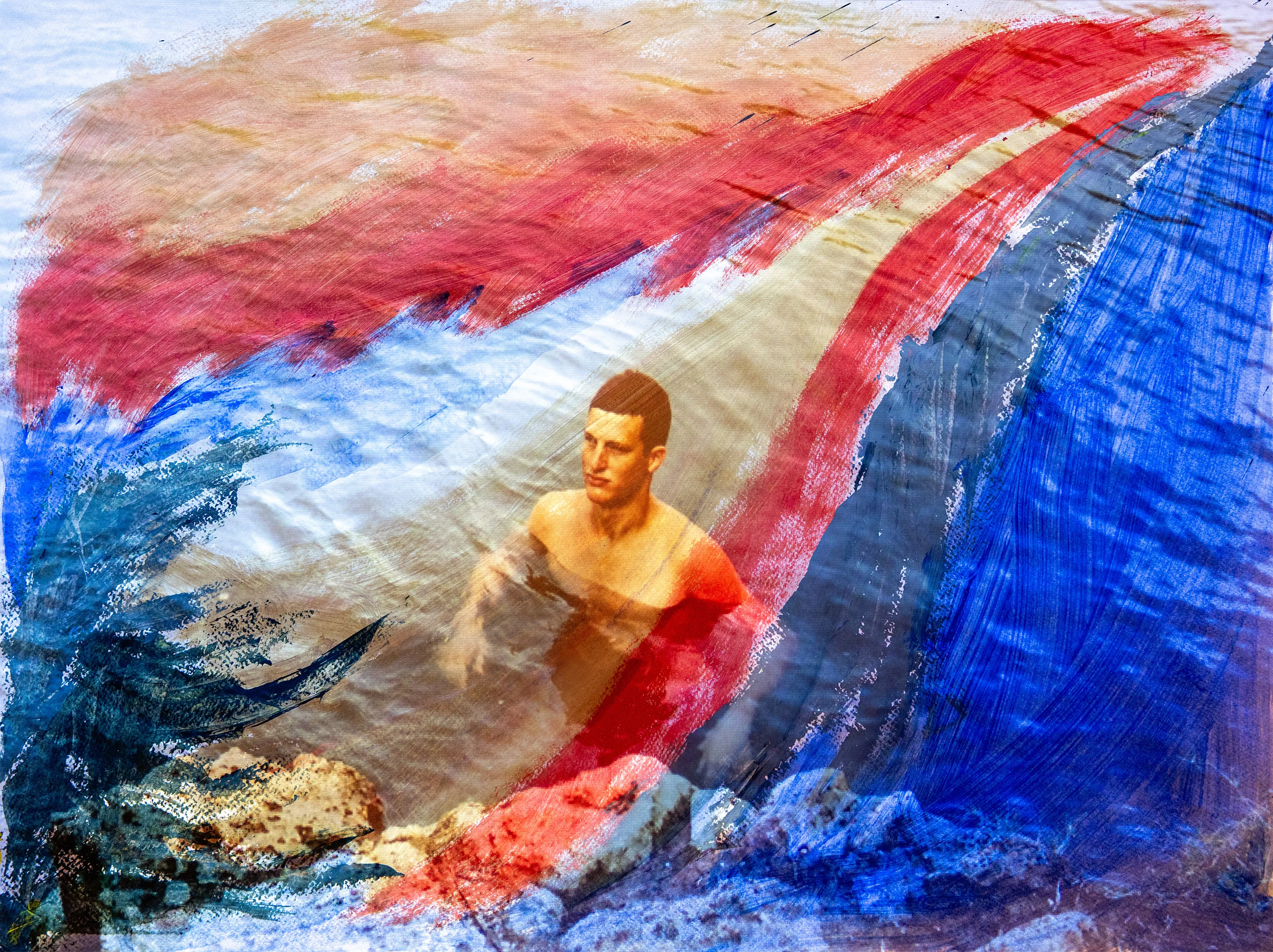 A man stands in water beside a band of red, white and blue paint.