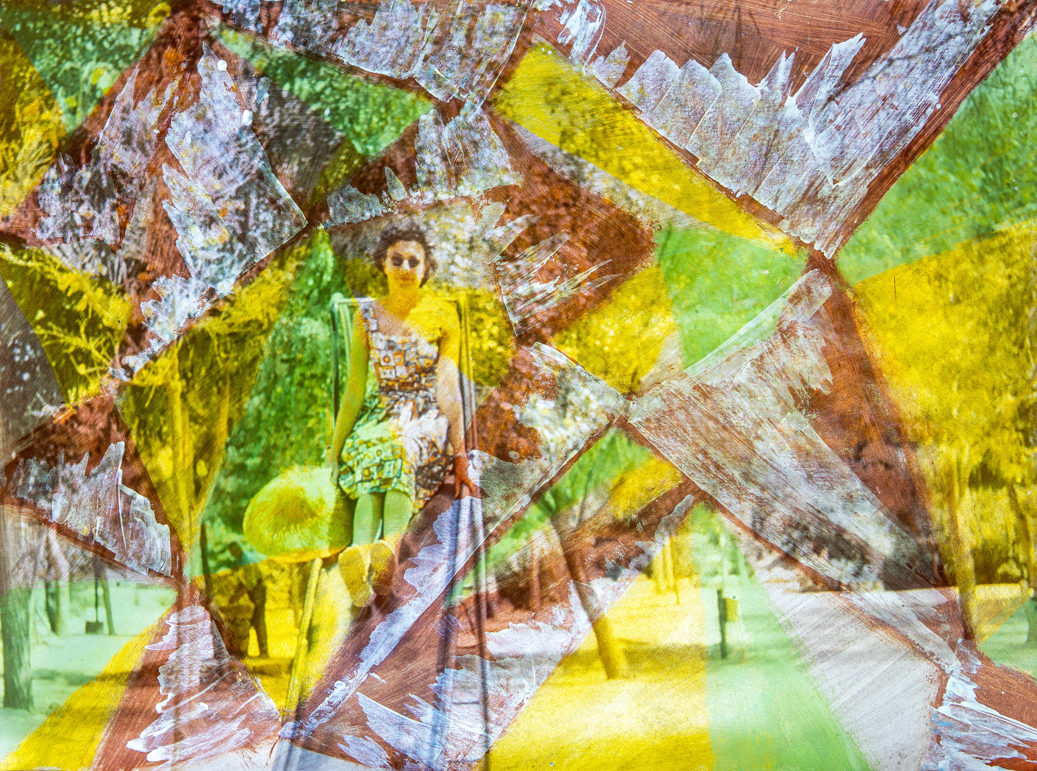 A figure stands on a park path, crossed by diagonal lines of yellow and green paint.