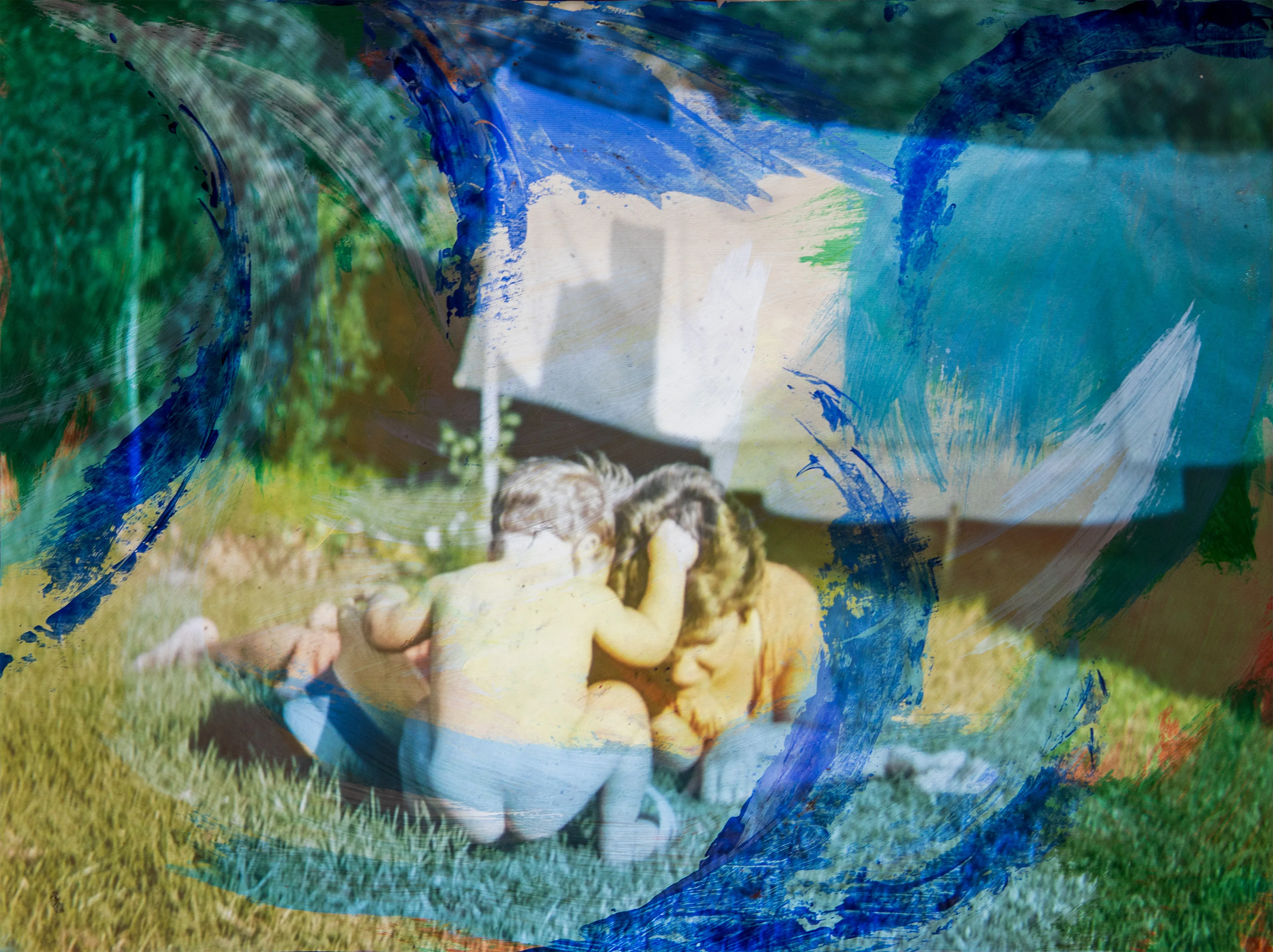 Two small children sit close together on grass, partly covered by sweeps of blue paint.