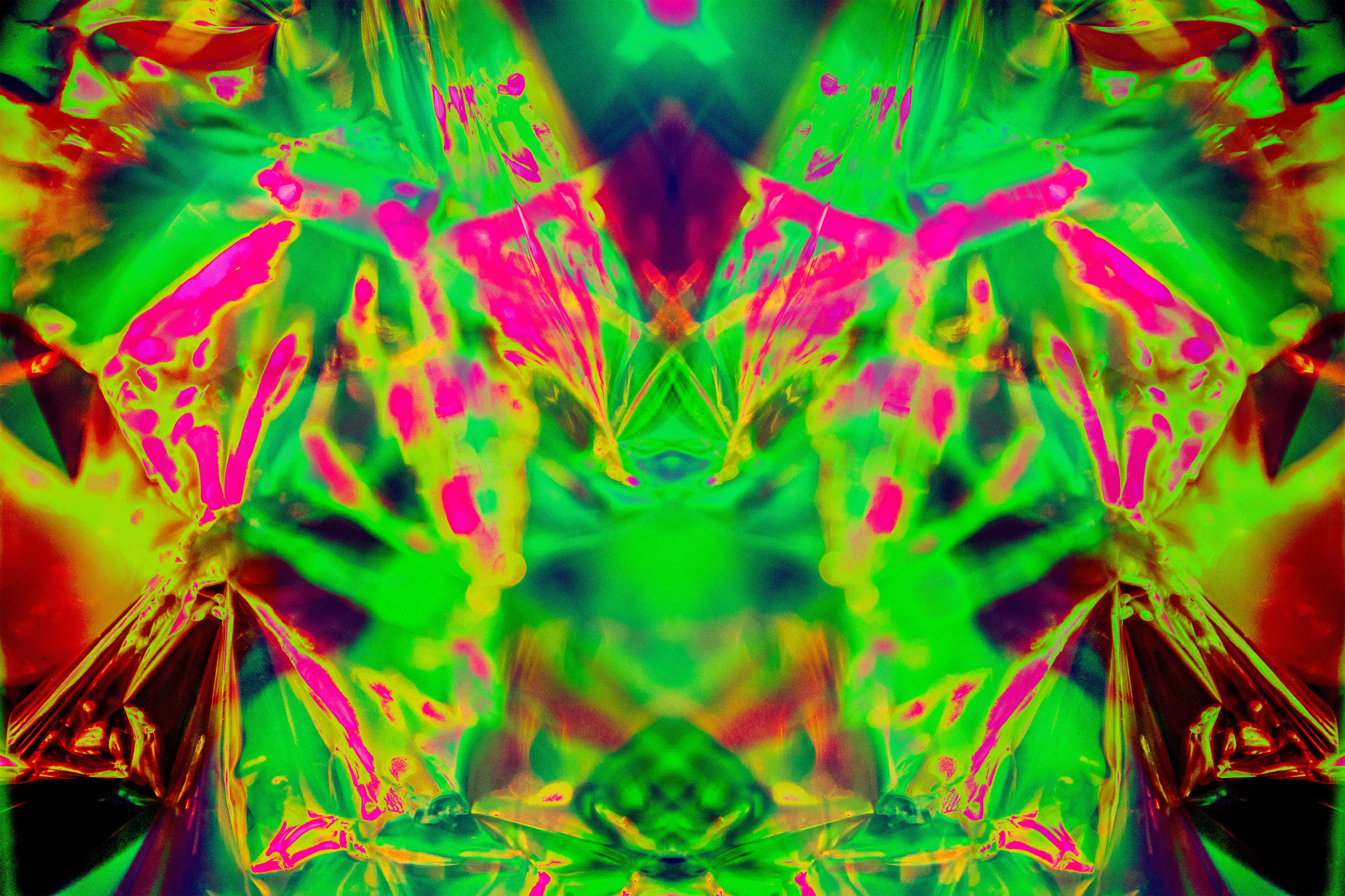A wide mirrored composition in bright green, magenta and yellow-green with dark red edges.